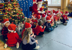Podczas ustawiania się do zdjęcia, dzieci podejmują rozmowę z Mikołajem.