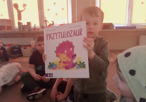 Kubuś pokazuje swoją książkę "Przytulozaur"