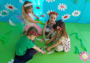 Dziewczynki układają puzzle z oznakami wiosny