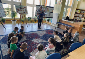 Pani Jola czyta dzieciom wiersz o zajączkach.