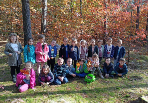 Grupowe zdjęcie dzieci w lesie.